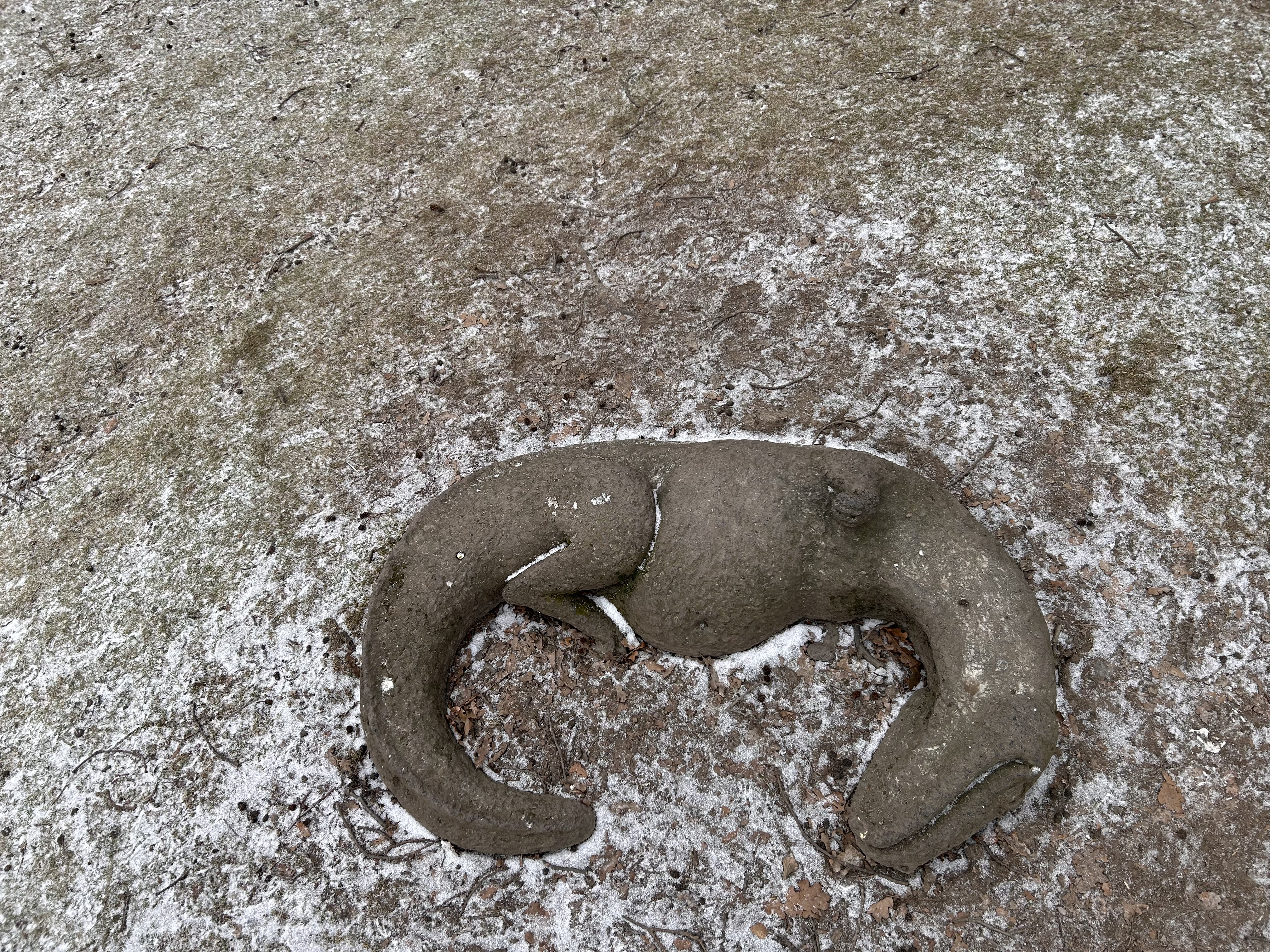 Animal sculpture covered in frost on the ground in Slottsskogen